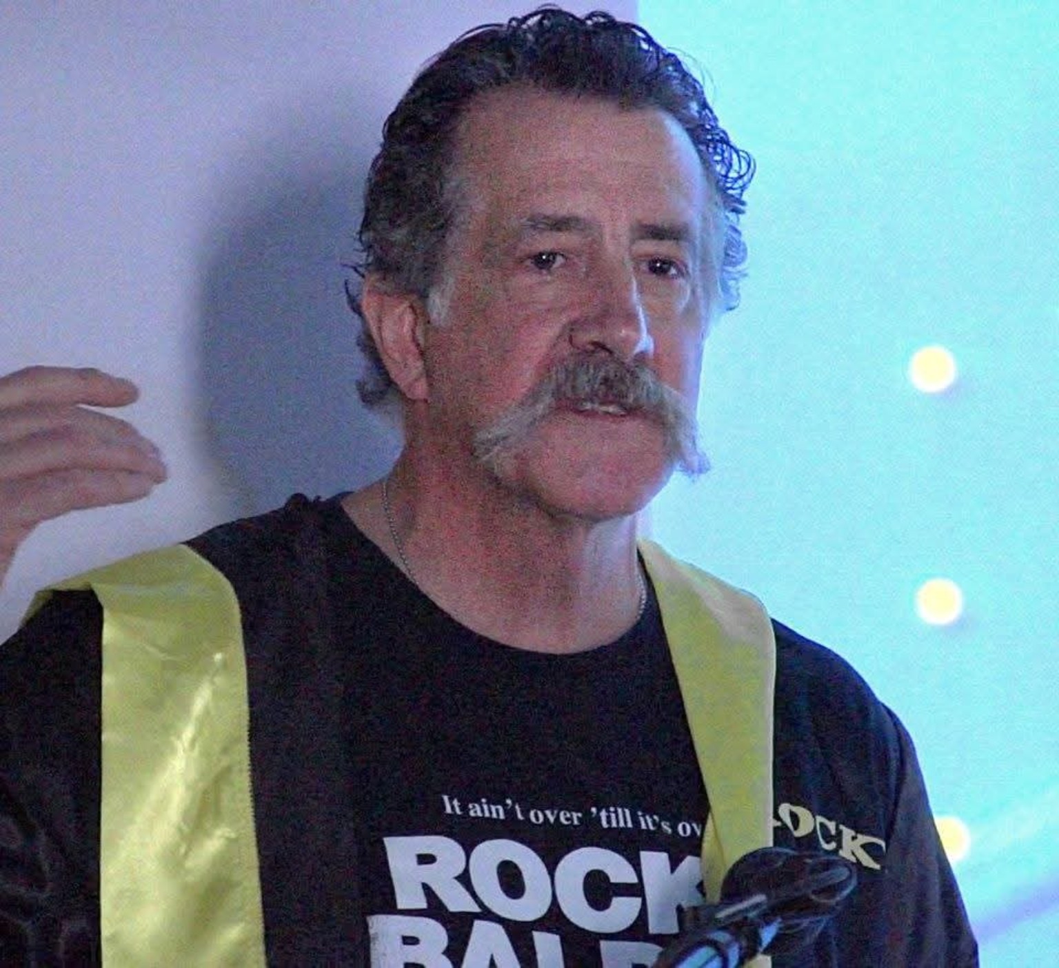 Dr. Jim Caridi presenting at Retreat From Cancer dressed as Rocky
